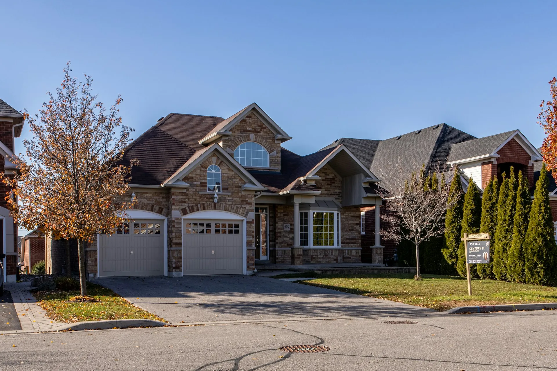 Stone-front home with two carriage-style garage doors