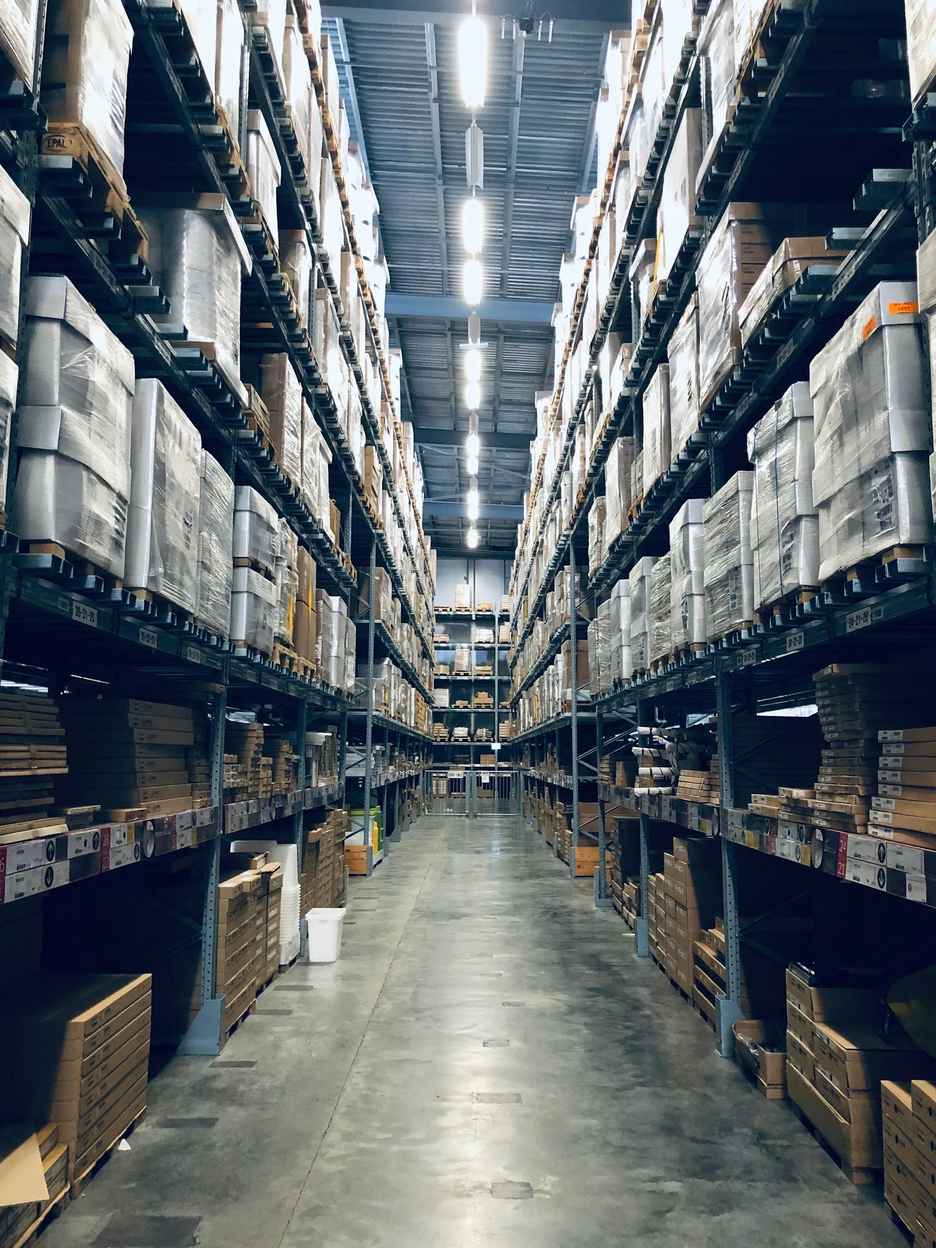 Warehouse aisle lined with tall shelving